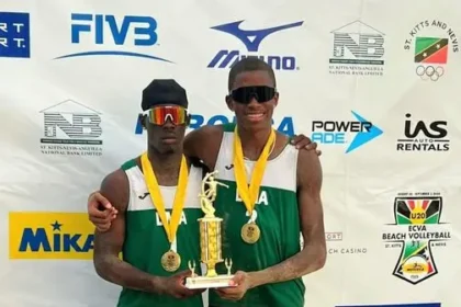 Dominica's Under-21 men's beach volleyball team celebrating their victory at the ECVA Championship.