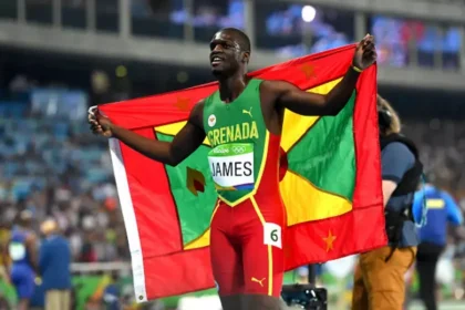 Kirani James, Grenadian sprinter, posing with his silver medal from the Rome Diamond League 400m race.