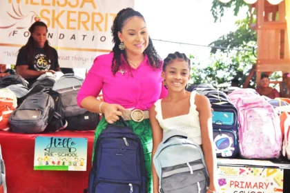 Melissa Skerrit Foundation volunteers distributing backpacks filled with school supplies at Peebles Park.