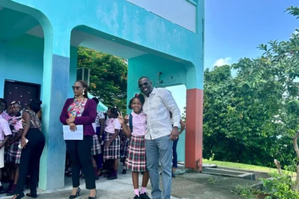 Minister Samal Duggins distributing school supplies to students during his visit to Verchilds High School and Tyrrell Williams Primary School.