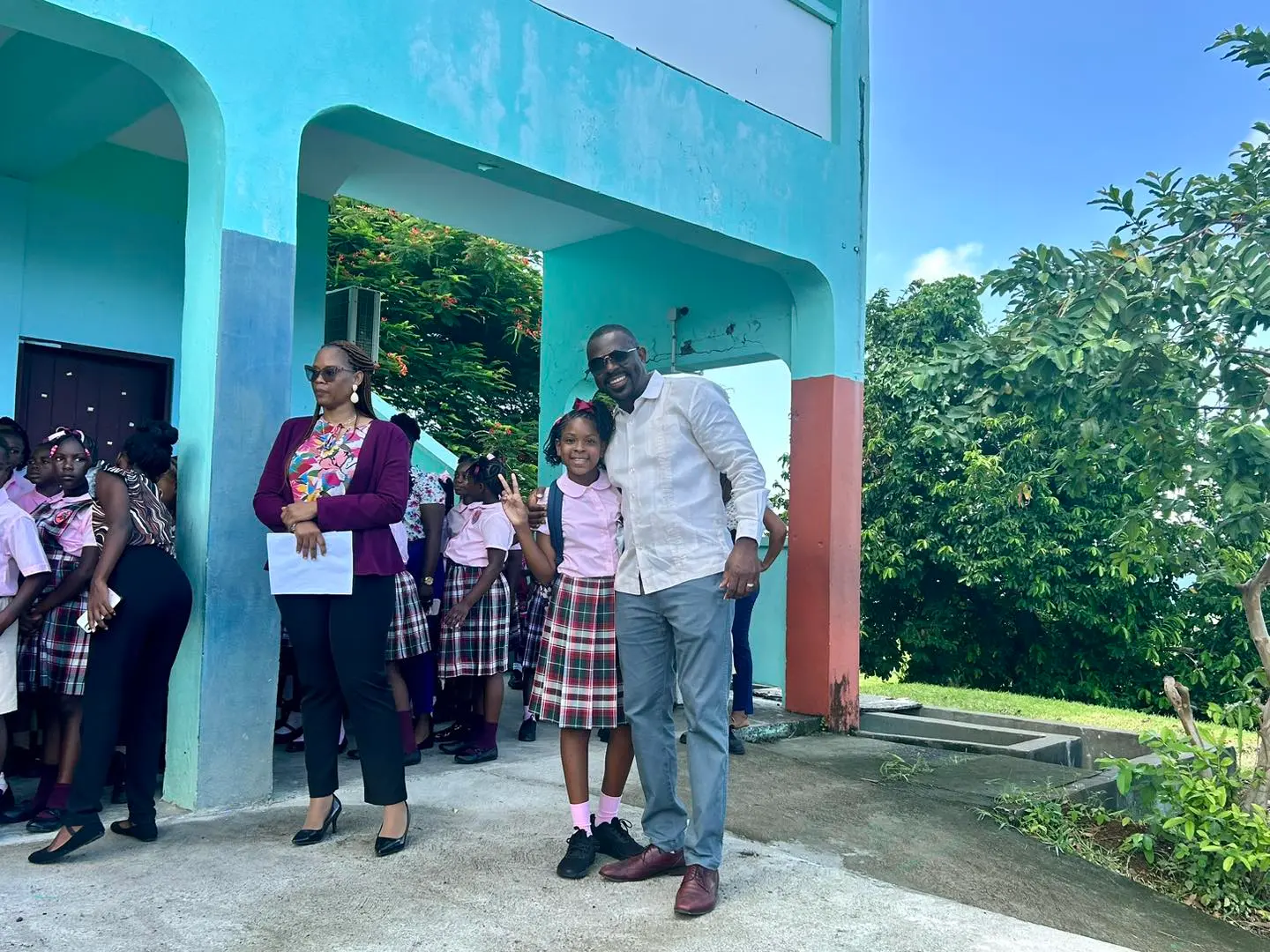 Minister Samal Duggins distributing school supplies to students during his visit to Verchilds High School and Tyrrell Williams Primary School.