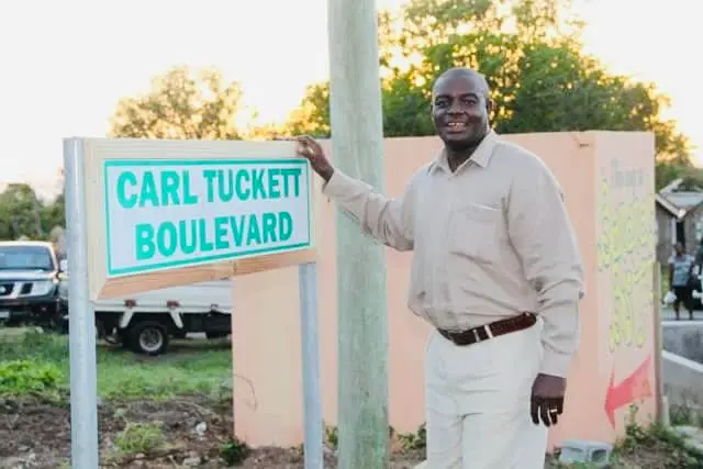 Premier Mark Brantley visiting Carl Tuckett to congratulate him on becoming an international cricket umpire.
